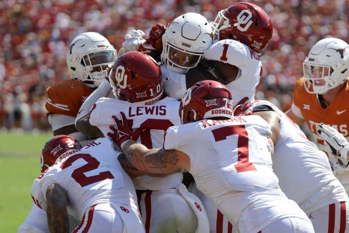 Oklahoma Sooners defensive back Billy Bowman Jr. (2), Oklahoma Sooners linebacker Kip Lewis (10), Oklahoma Sooners linebacker Jaren Kanak (7) and Oklahoma Sooners linebacker Dasan McCullough (1) stop Texas Longhorns running back Jonathon Brooks